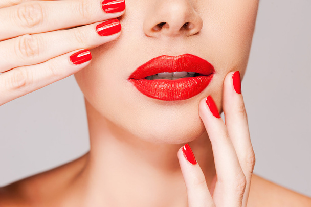Woman holding finger on her red lips - Фото, изображение