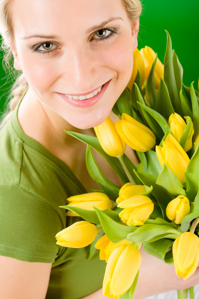 Young woman hold yellow tulips flower - Zdjęcie, obraz