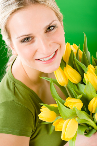 Young woman hold yellow tulips flower - Фото, зображення