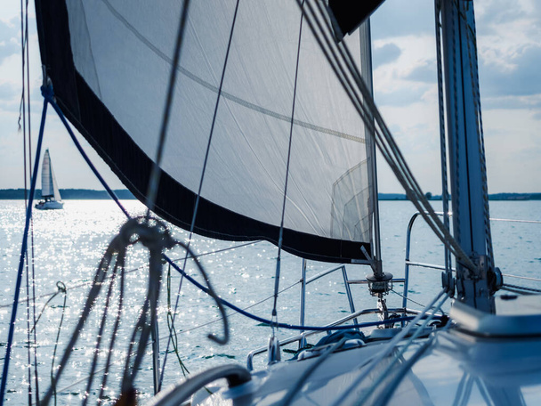 close up view on white sailing yacht or sailboat bow sailing on a lake - Photo, image