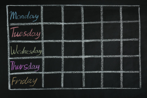 Weekly school timetable drawn on black chalkboard - Foto, Imagem