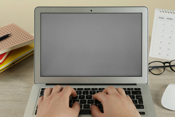 Woman using laptop for online studying at wooden table, closeup. Distance learning - Photo, Image