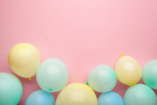 Birthday background with colorful balloons on pink background, top view. Happy birthday - Фото, зображення
