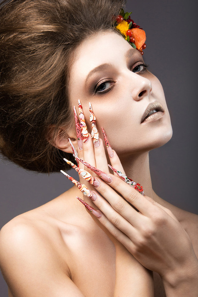 Beautiful girl in autumn image with long nails with bright and unusual make-up. - Photo, Image