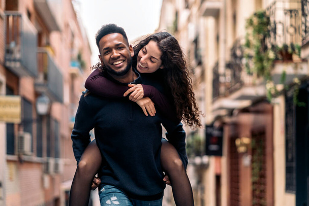 Happy Interracial Couple doing piggyback - Φωτογραφία, εικόνα