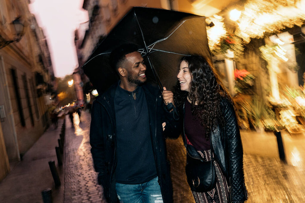 Interracial Couple Under the Rain - Photo, image