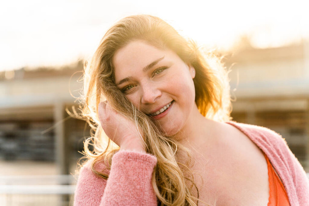 Beautiful and cheerful plus size young woman outdoors - Pretty overweight curvy female, concepts about femininity, women power, female emancipation, body positivity and body acceptance - Фото, зображення