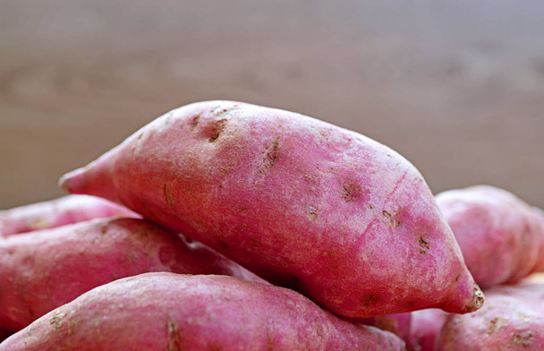 Closeup of Raw Sweet Potato on a Pile - 写真・画像