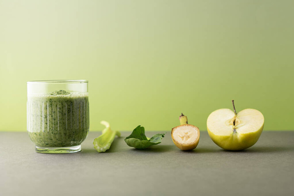 Composition with a glass of delicious detox juice (smoothie) and ingredients on colour background - Foto, immagini