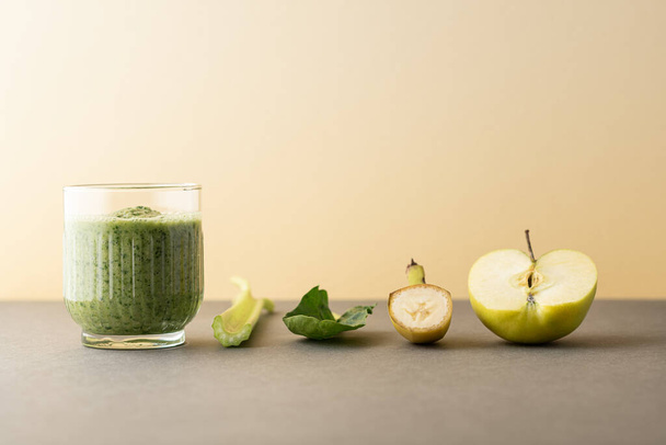 Composition with a glass of delicious detox juice (smoothie) and ingredients on colour background - Valokuva, kuva