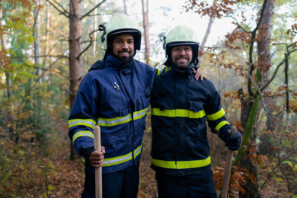 Happy firefighters men after action, stopping fire in forest and looking at camera. - Fotografie, Obrázek