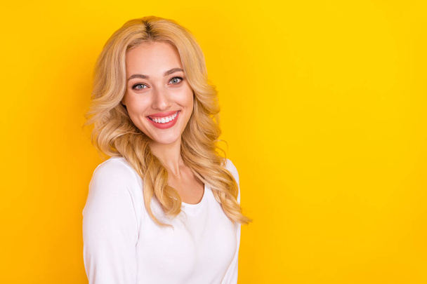 Photo of pretty sweet lady dressed white shirt smiling empty space isolated yellow color background - 写真・画像