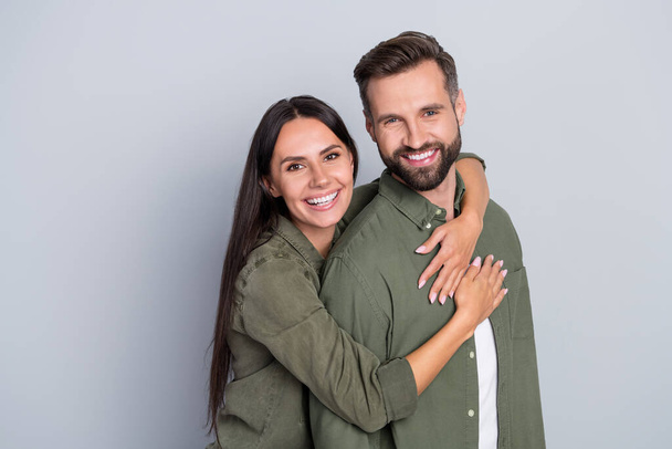 Portrait of attractive cheerful amorous couple best friends hugging romance spending time isolated over grey pastel color background - Foto, immagini