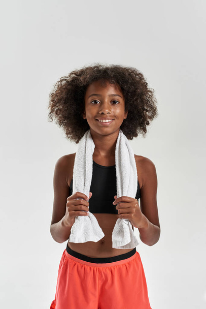 Curly smiling black girl with towel look at camera - Foto, Bild