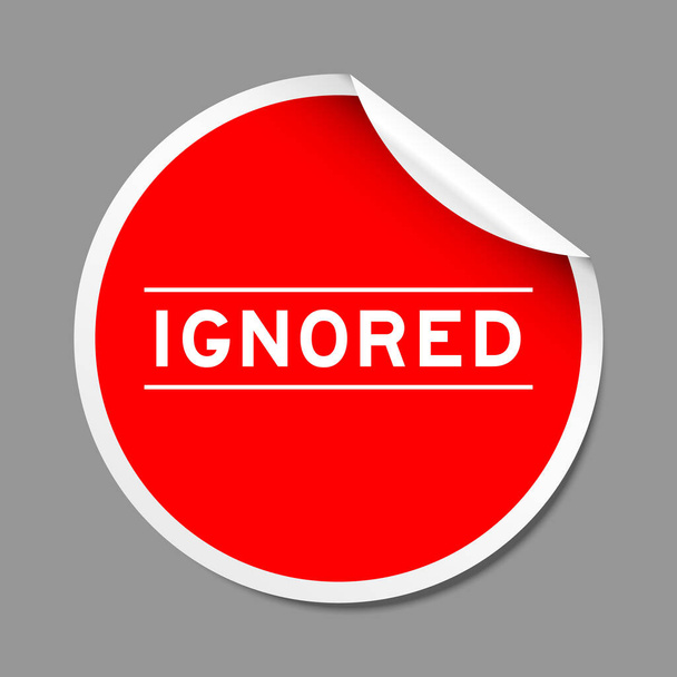 Red color peel sticker label with word ignored on gray background - Vetor, Imagem