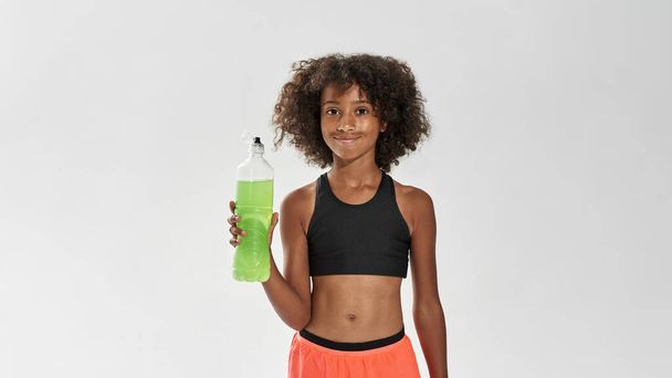 Athletic black girl with bottle of sport drink - Valokuva, kuva