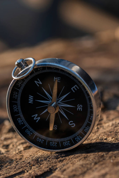 Close up shot of a silver metal compass always pointing it's needle towards North - Fotografie, Obrázek