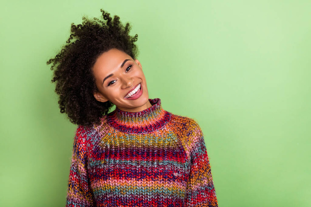 Photo of impressed young valume hairdo lady wear colorful sweater isolated on green color background - Foto, afbeelding