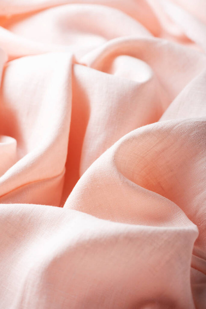 Wavy linen fabric in pink petal color, selective focus image - Foto, afbeelding