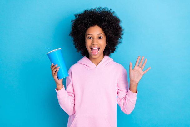 Portrait of attrctive trendy funky amazed cheerful girl drinking soda having fun free time isolated over vibrant blue color background - Zdjęcie, obraz