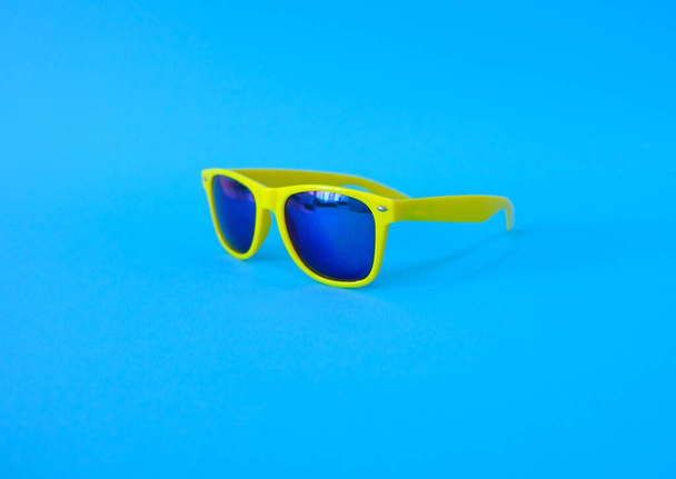 Sunglasses on a blue background. High quality photo - Foto, immagini