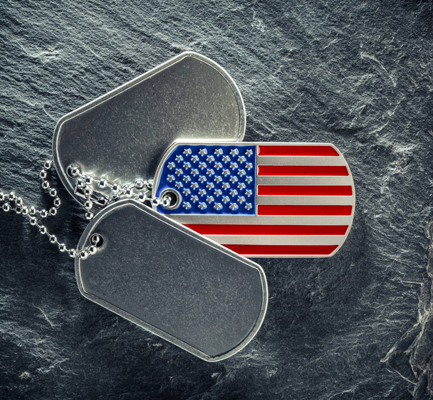 US military soldier's dog tags, rough and worn with blank space for text, and in the shape of the American flag. Memorial Day for Veterans Day concept. - Photo, Image