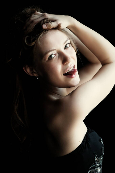 Portrait of beautiful sexy girl on a black background - Foto, Imagen