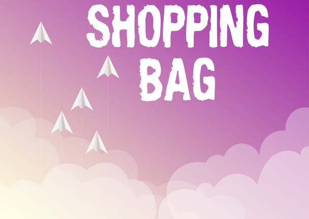 Text sign showing Shopping Bag. Business concept Containers for carrying personal possessions or purchases Five paper airplanes flying up sky surrounded with clouds achieving goals. - Фото, изображение