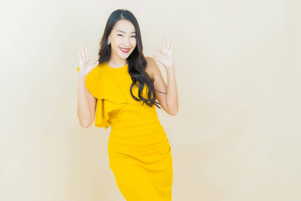 Portrait beautiful young asian woman smile with action on color background - Photo, Image