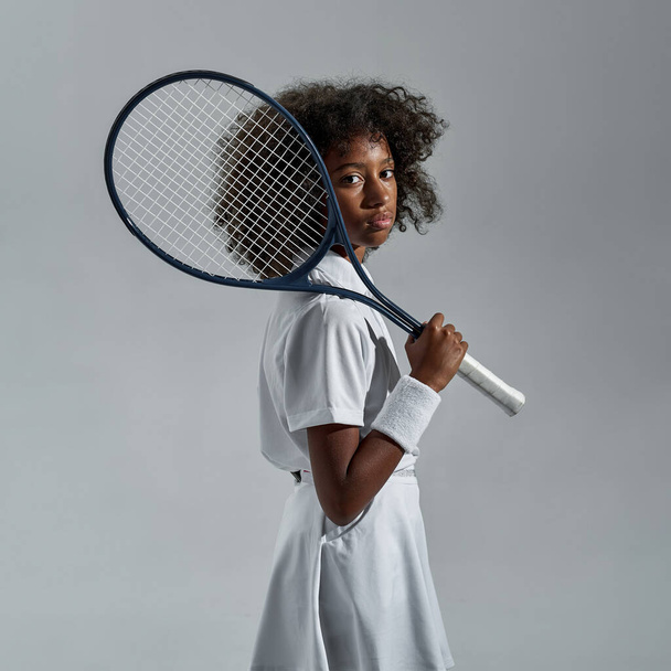 Side view of confident black girl tennis player - Фото, изображение