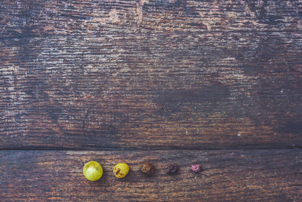 Macro view of raisins vine grapes with wooden barrel, table texture background - Photo, Image