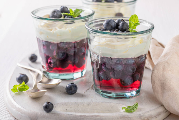 Delicious and tasty jelly made of fruits and cream. Jelly with fruits and whipped cream. - Φωτογραφία, εικόνα
