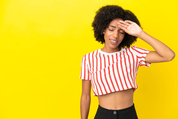 Young African American woman isolated on yellow background with tired and sick expression - Fotó, kép