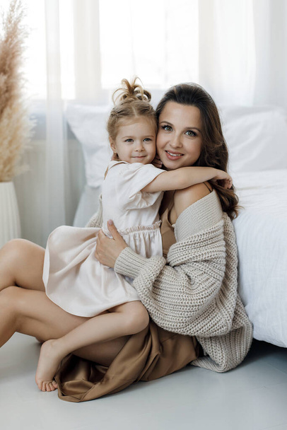 mother and lovely baby and daughter indoor at home - Фото, изображение