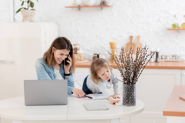 mother and daughter working together at home - Photo, Image
