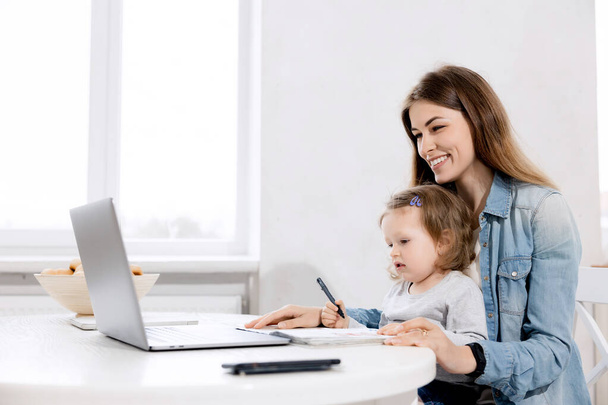 mother and daughter working together at home - Photo, image