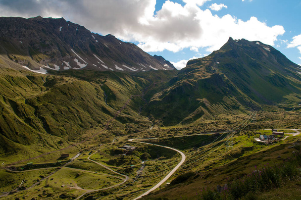 Droga Nufenenenpass prowadzi przez dolinę pomiędzy wysokimi górami Alp Szwajcarskich - Zdjęcie, obraz
