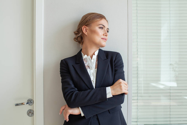 Young business woman in suit looking aside - Photo, image