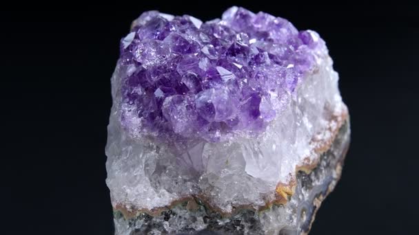 Amethyst Close Up. Close up view of an Amethyst rock rotating in the dark background. - Footage, Video
