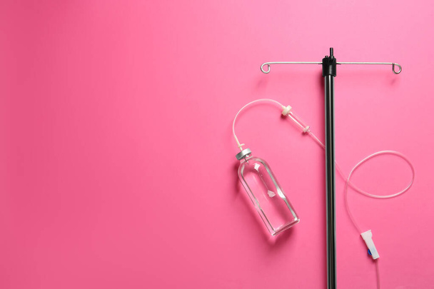 IV infusion set on pink background, flat lay. Space for text - Foto, immagini