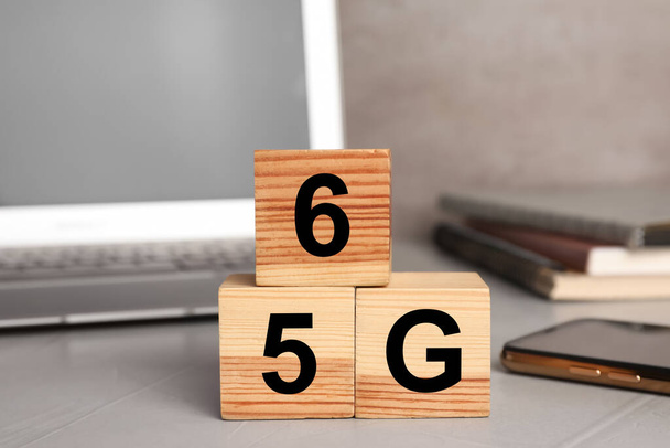 5G and 6G technology, Internet concept. Wooden cubes on light office table, closeup - Фото, зображення