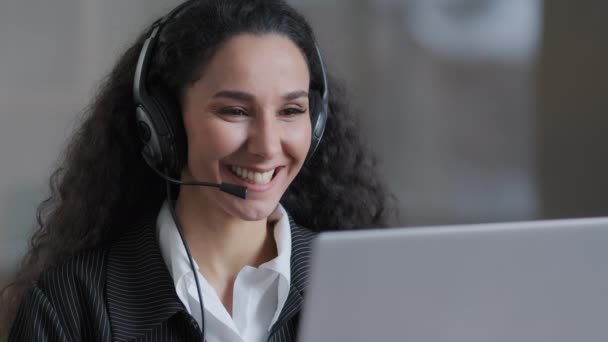 Cheerful young worker business woman girl holding video conference call with client partner wear headphones with microphone provide support service advises customer skilled happy lady working online - Footage, Video