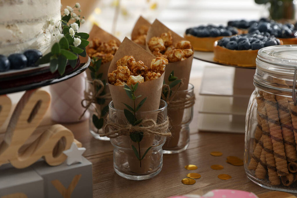 Delicious party treats on wooden table indoors - Фото, изображение