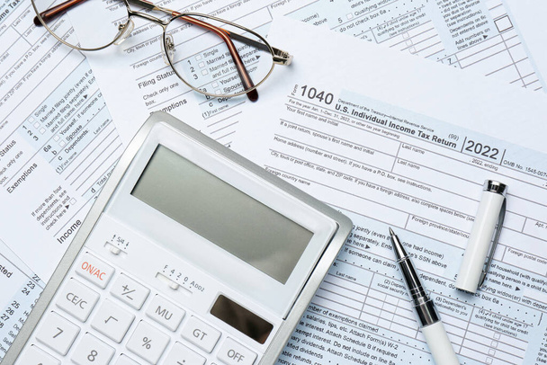 Calculator, glasses and pen on documents, flat lay. Tax accounting - 写真・画像