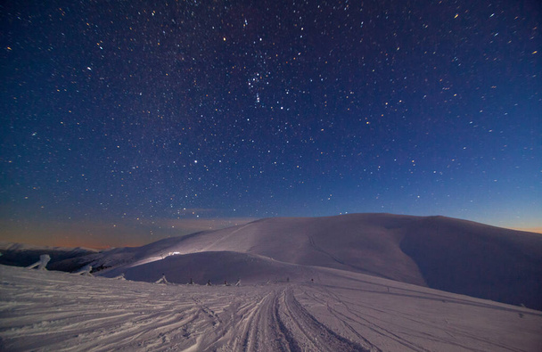 Fantastic starry sky. Winter landscape and snow-capped peaks. Carpathian mountains. Ukraine. Europe - Photo, Image