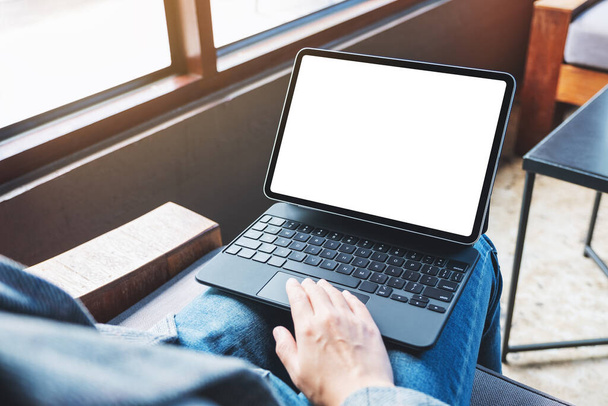 Mockup image of a woman using and touching on tablet touchpad with blank white desktop screen as a computer pc  - Zdjęcie, obraz