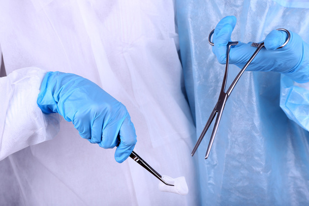 Surgeon's hands holding different instruments close up - Foto, Imagem