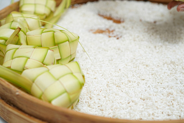 The composition of rice and ketupat which is a traditional food to celebrate Eid for Indonesian Muslims. - Foto, imagen