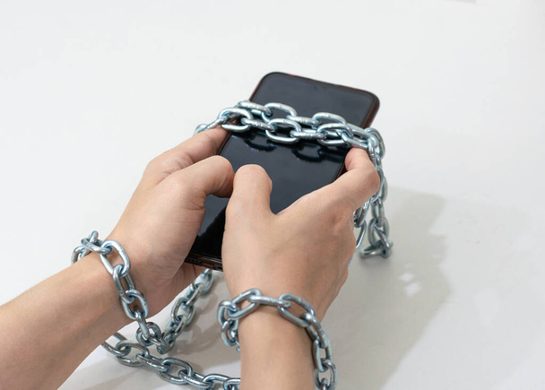 Mobile phone chained social media concept to the hands telephone  - Foto, afbeelding