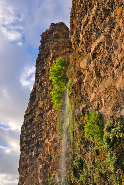 Cascata dos Anjos, Angels Waterfall, located in the civil parish of Anjos, municipality of Ponta do Sol, the water cascades directly onto the coastal road. Madeira, Portugal - Foto, Imagen